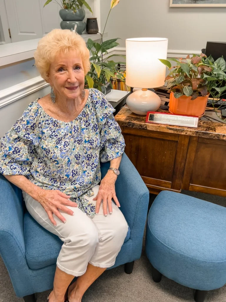 A counselor seated in a counseling room with a lamp